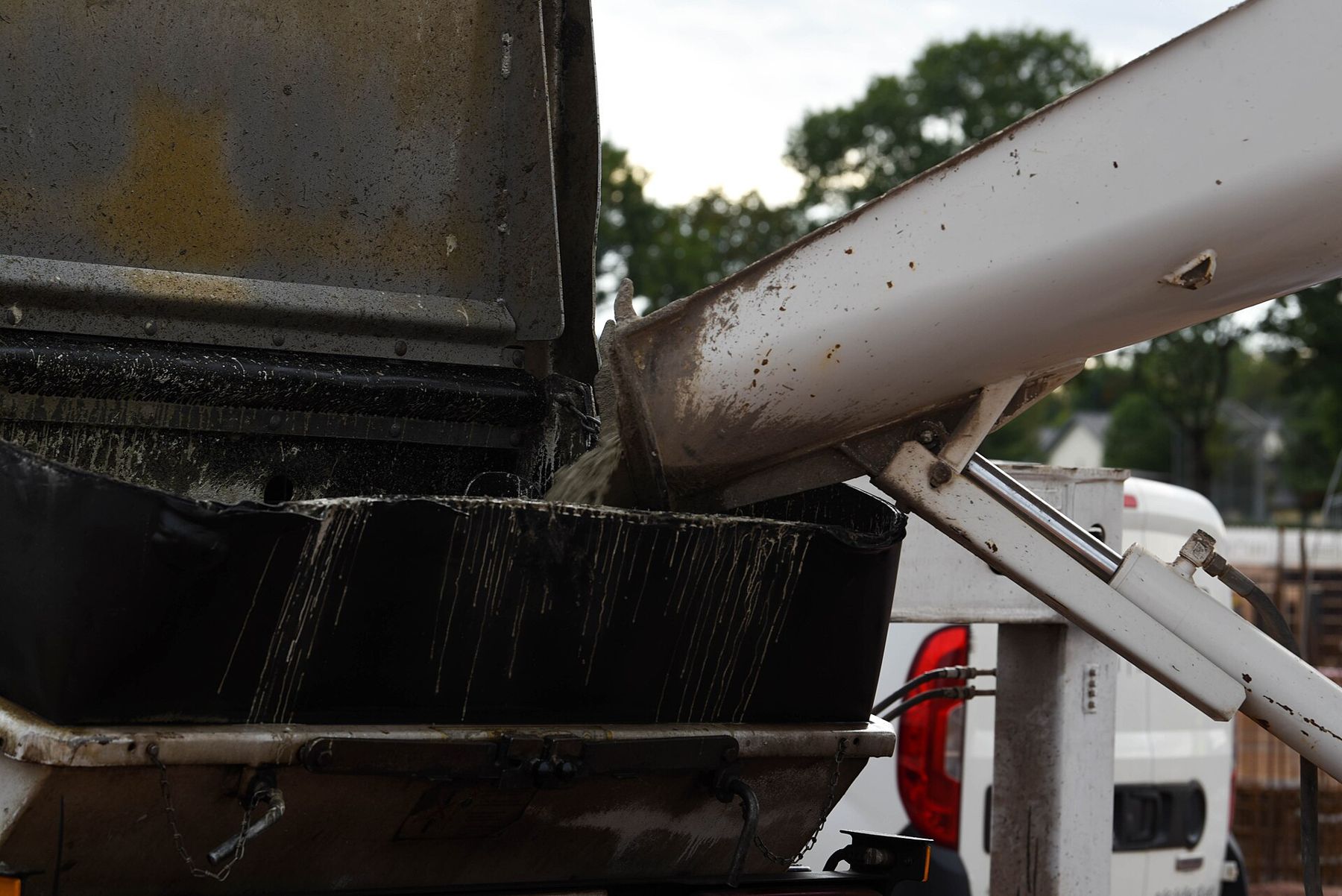 Fresh concrete flowing down a mixer truck chute